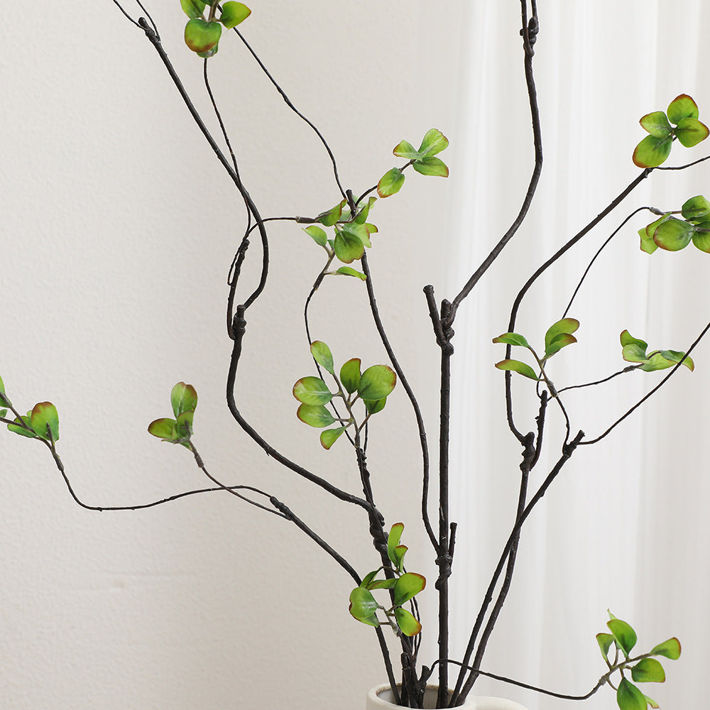 Artificial flower branch with vibrant orange flowers