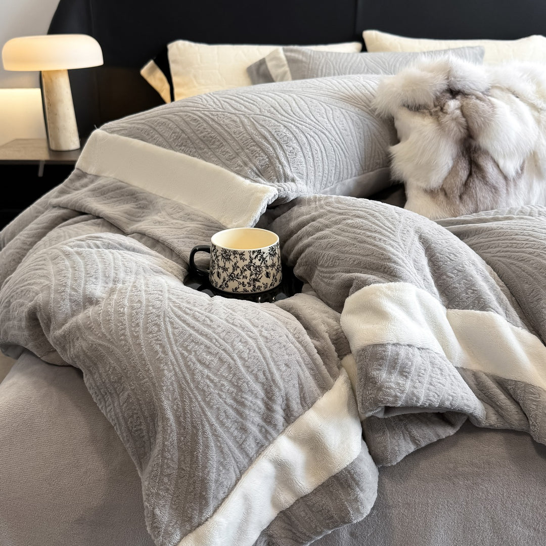 Quilted bedding set made of cotton blend with raised leaf texture and contrasting border