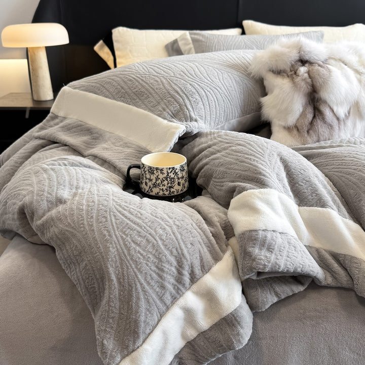 Quilted bedding set made of cotton blend with raised leaf texture and contrasting border