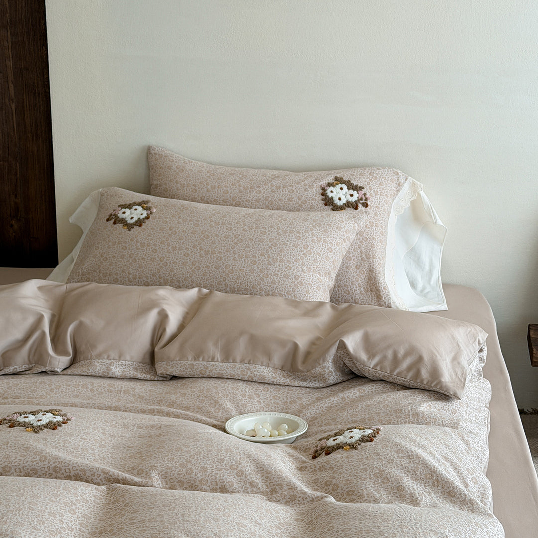 Embroidered bed set made of fine cotton satin with gathered bed skirt and decorative pillows