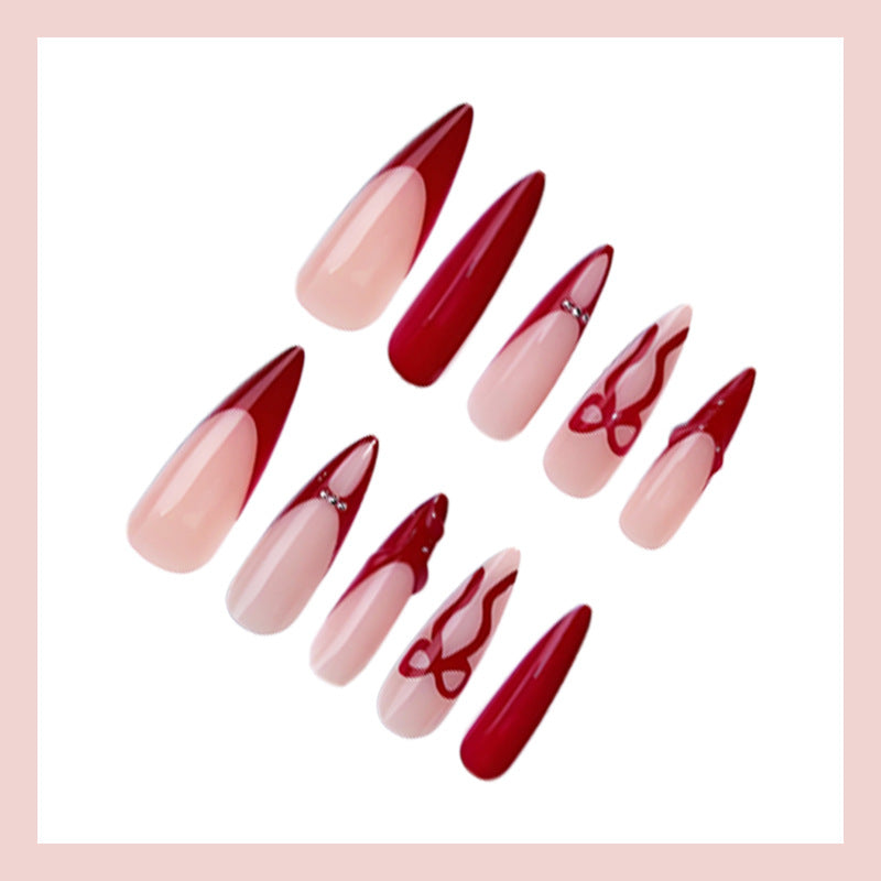 Artificial nails with elegant pointed designs and creative embellishments Stornfield