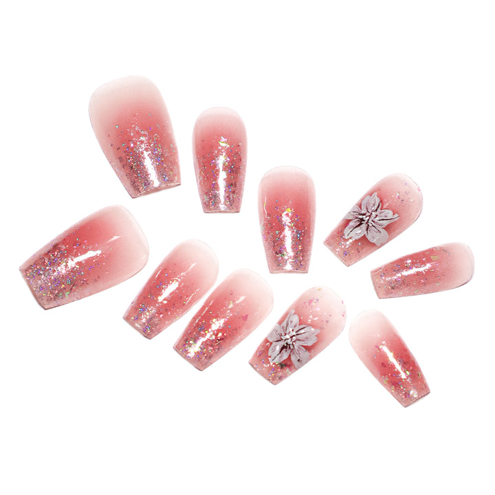 Artificial nail extensions with floral design and glitter accents Stornfield