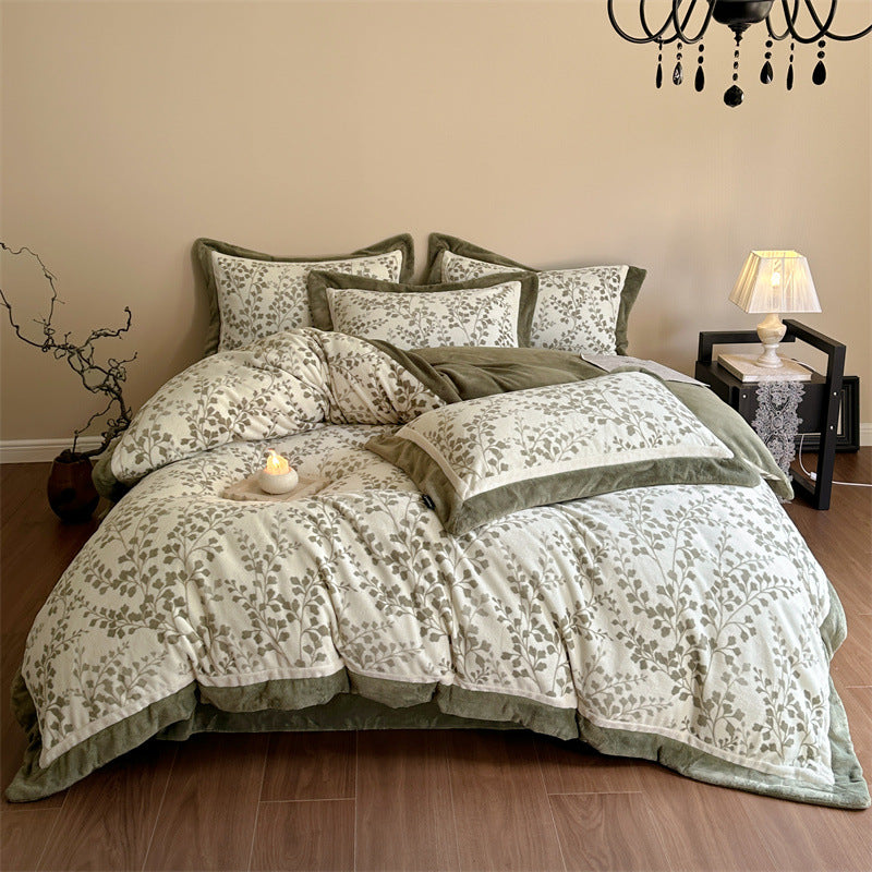 Luxurious quilted bedding set with velvet trim and floral branch motif