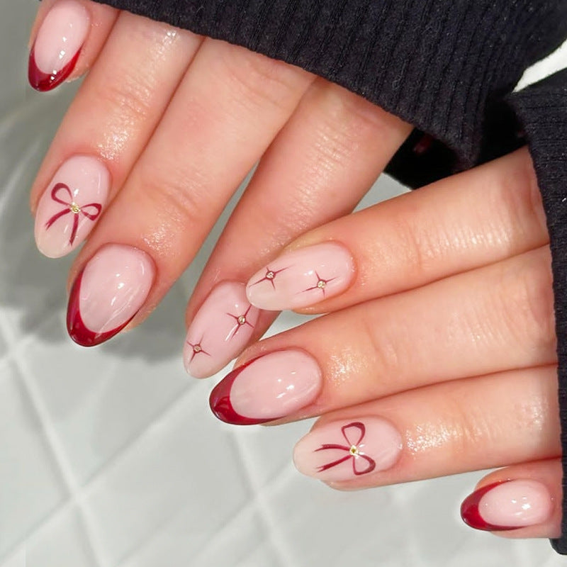 Acrylic nail set with elegant arch design and glitter effects Stornfield