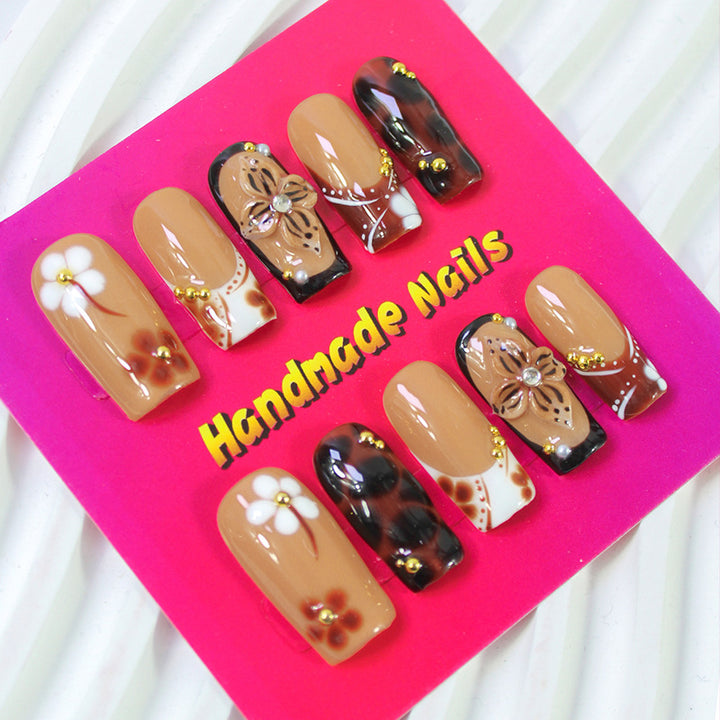 Acrylic nail set with elegant handcrafted designs and decorative accents Stornfield