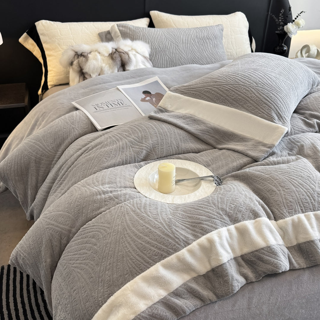 Quilted bedding set made of cotton blend with raised leaf texture and contrasting border