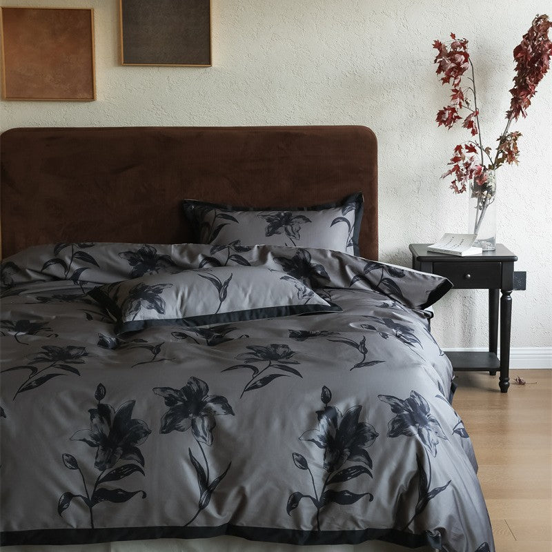 Cotton satin bedding set with subtle botanical print and contrasting hem edge