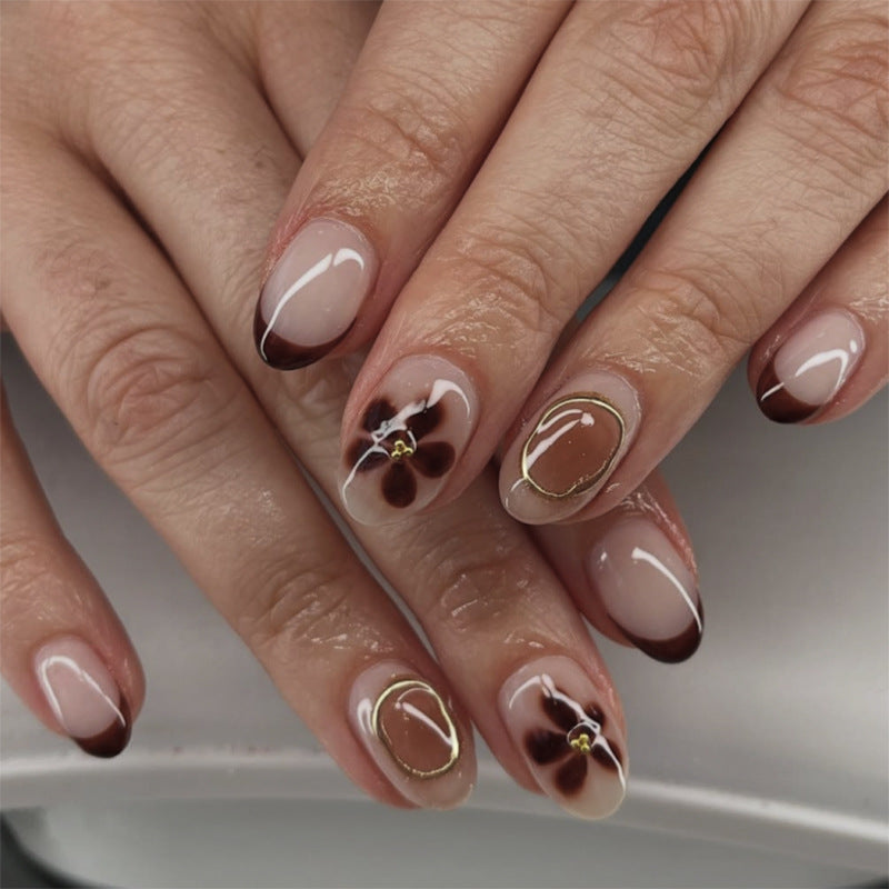 Elegant Nail Art with Floral Accents and Golden Details Stornfield