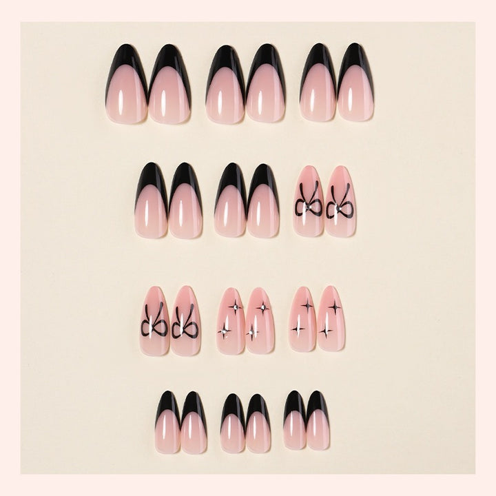 Acrylic nail set with elegant ombre design and creative bow motif Stornfield