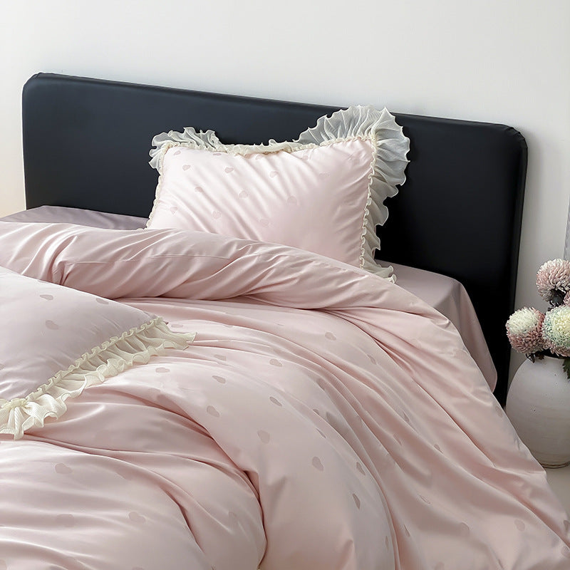 Elegant reversible bedding with romantic ruffle trim and subtle polka dot relief