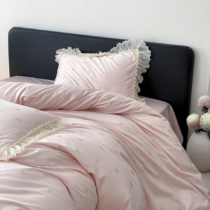 Elegant reversible bedding with romantic ruffle trim and subtle polka dot relief