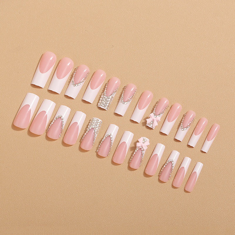 Artificial nails with glamorous rhinestone decorations and floral accents Stornfield