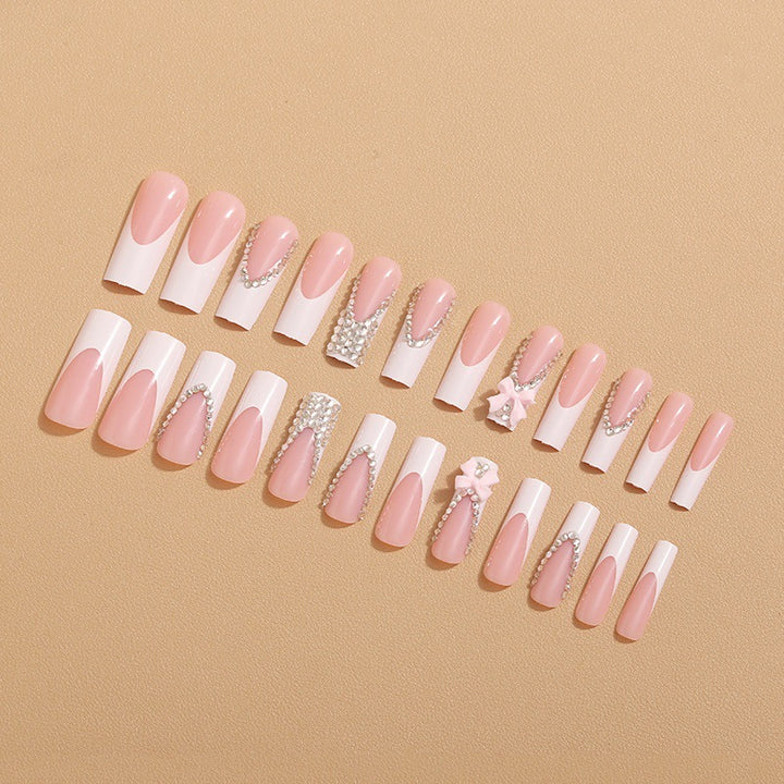 Artificial nails with glamorous rhinestone decorations and floral accents Stornfield