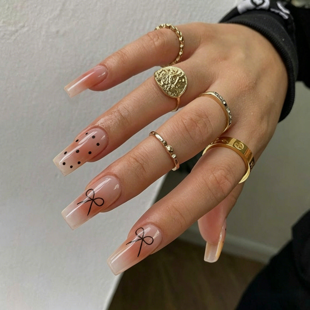 Artificial nails in luxurious French tip design with bow accents Stornfield