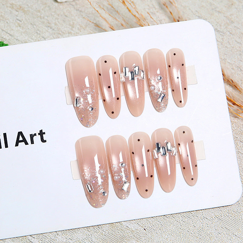 Artificial nail set with sparkling glitter and elegant jewelry details Stornfield
