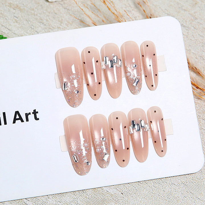 Artificial nail set with sparkling glitter and elegant jewelry details Stornfield