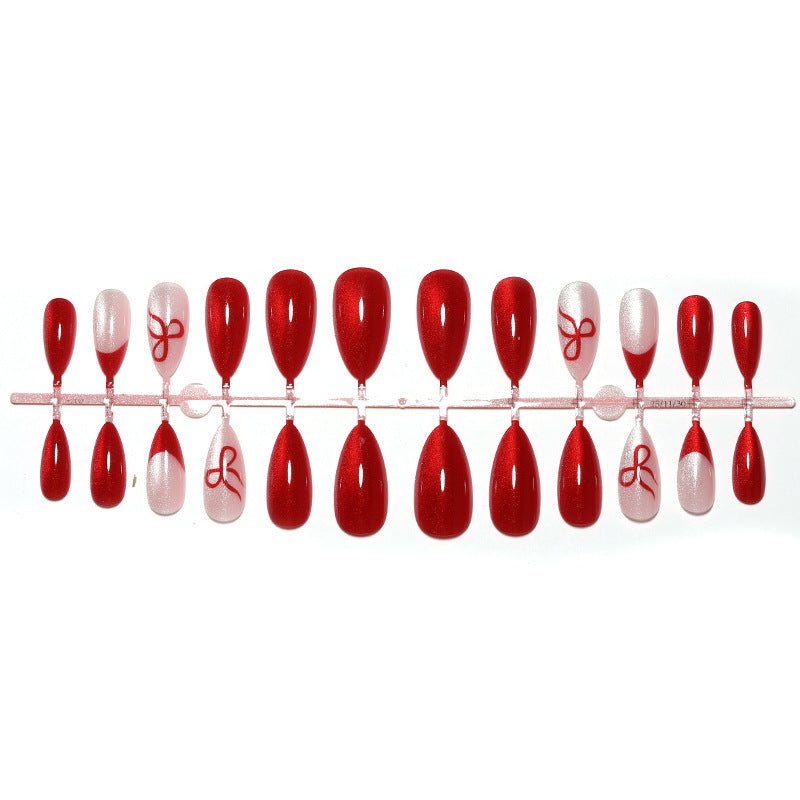 Artificial nail set with elegant red and delicate bow accents Stornfield