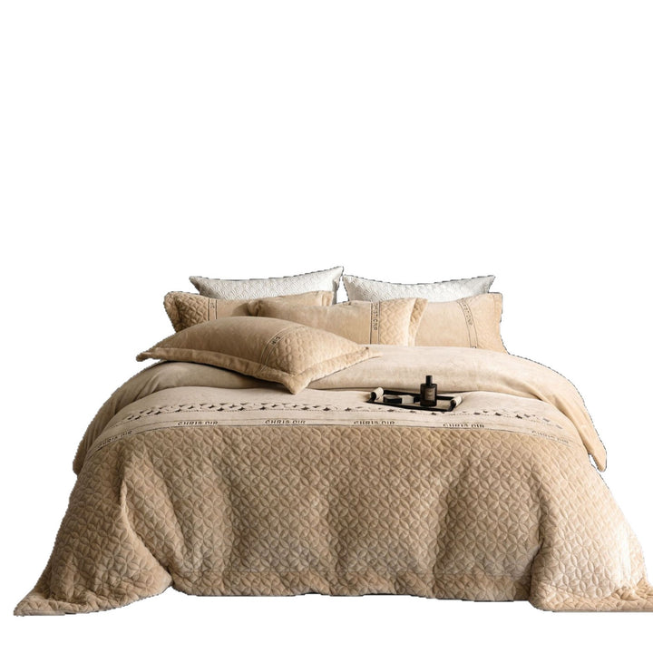 Quilted bedding set with geometric quilting and decorative ribbon