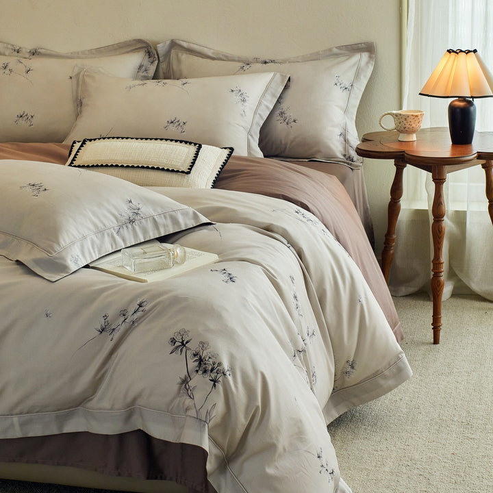 Luxurious cotton satin bed linen set with millefleurs floral pattern and fine piping