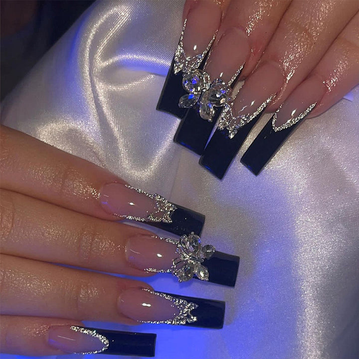 Glamorous artificial nails with rhinestone and butterfly elements Stornfield