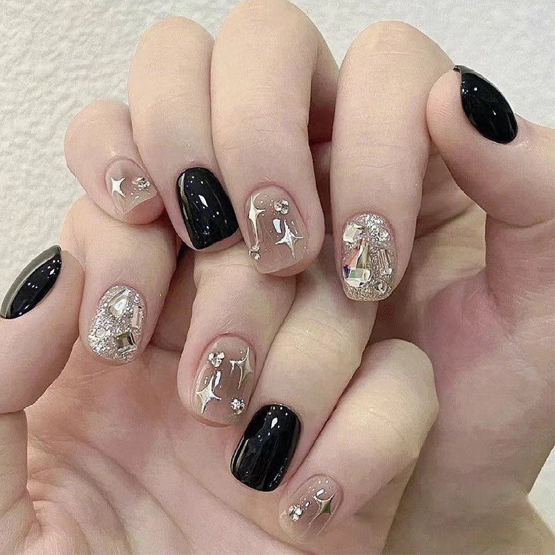 Elegant Nail Art with Glitter and Star Motifs Stornfield