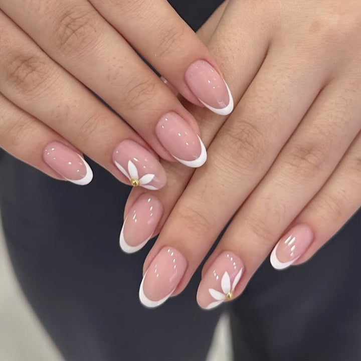 Artful French nails with delicate flowers and glitter accents Stornfield