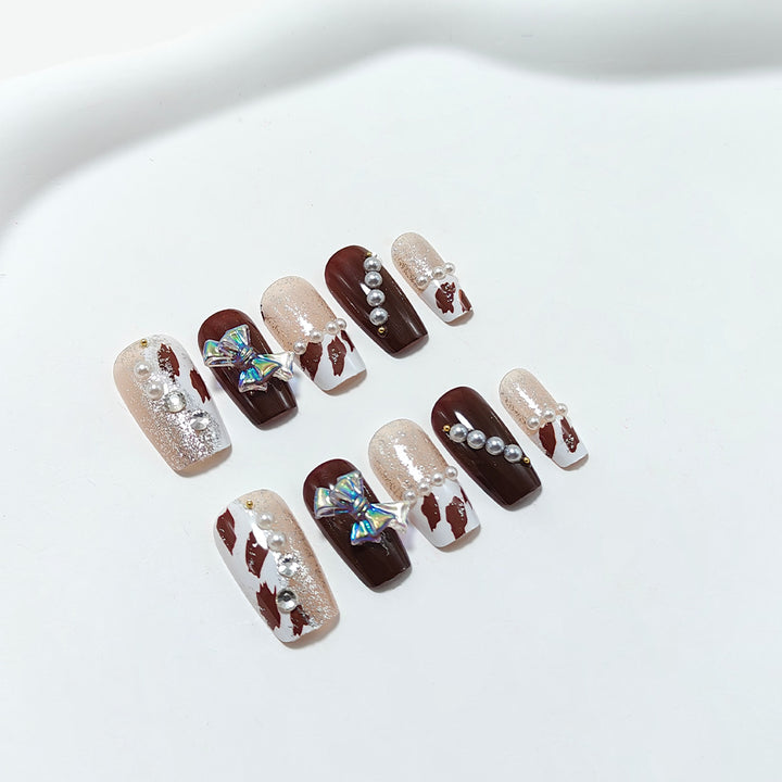 Artificial nails with glamorous rhinestone and bow design Stornfield