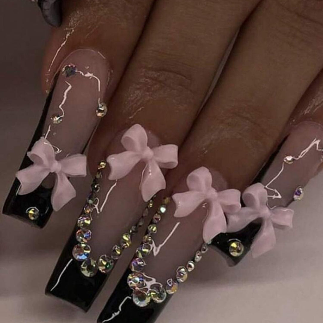 Artificial nails with elegant bows and rhinestone embellishments Stornfield