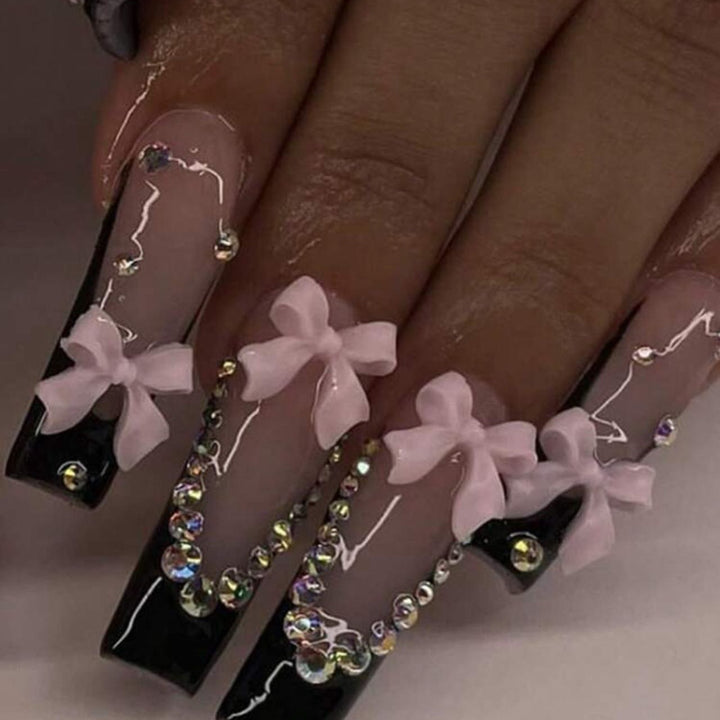 Artificial nails with elegant bows and rhinestone embellishments Stornfield