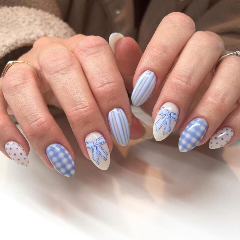 Artificial nail art with playful dots and bows Stornfield