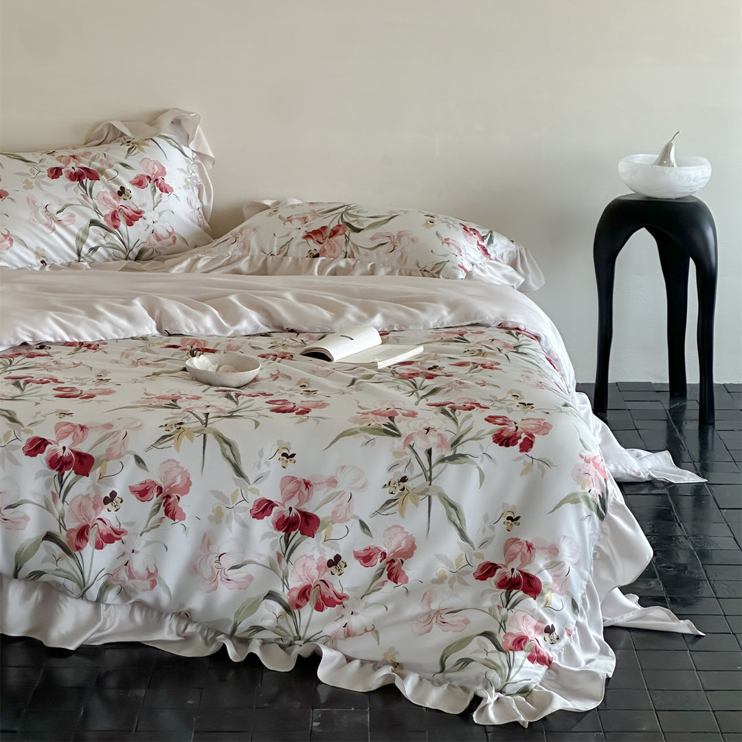 Luxurious satin bedding set with floral watercolor print, ruffled edges and reversible function
