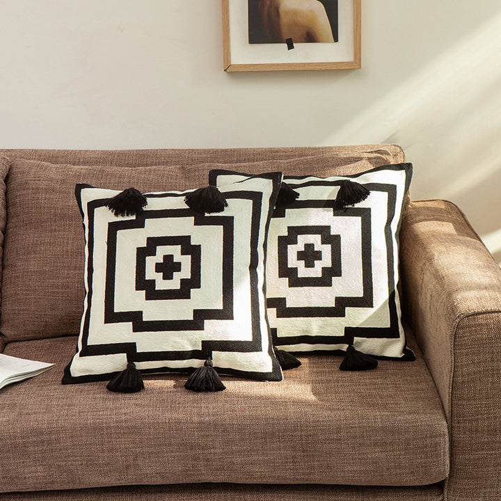 Square cushion cover in graphic geometric relief with decorative tassels