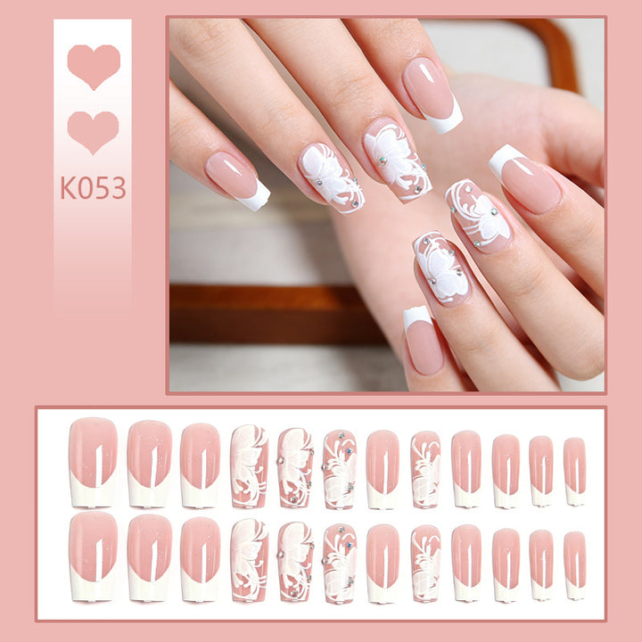 Artificial nails with floral embellishments and glitter details Stornfield
