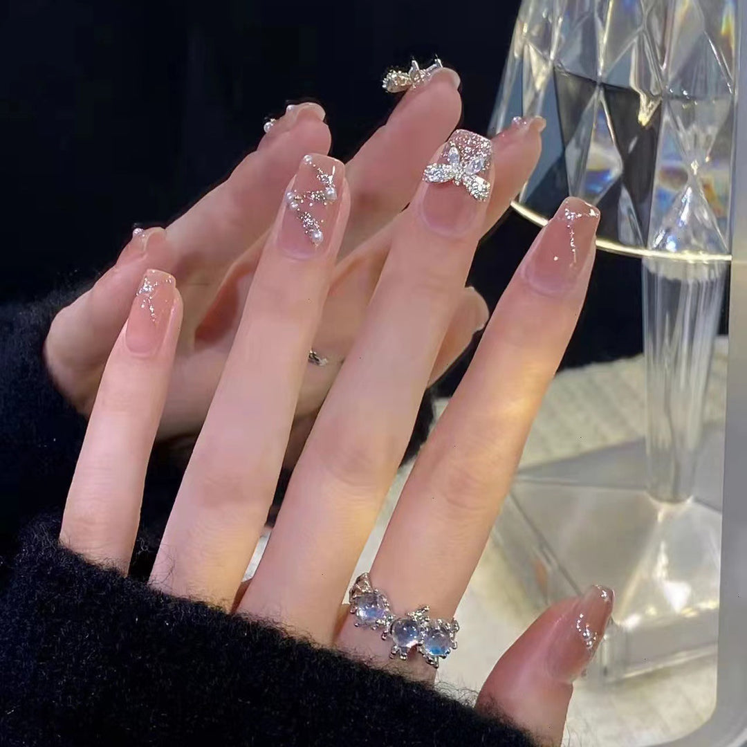 Artificial nails with heart and glitter accents Stornfield