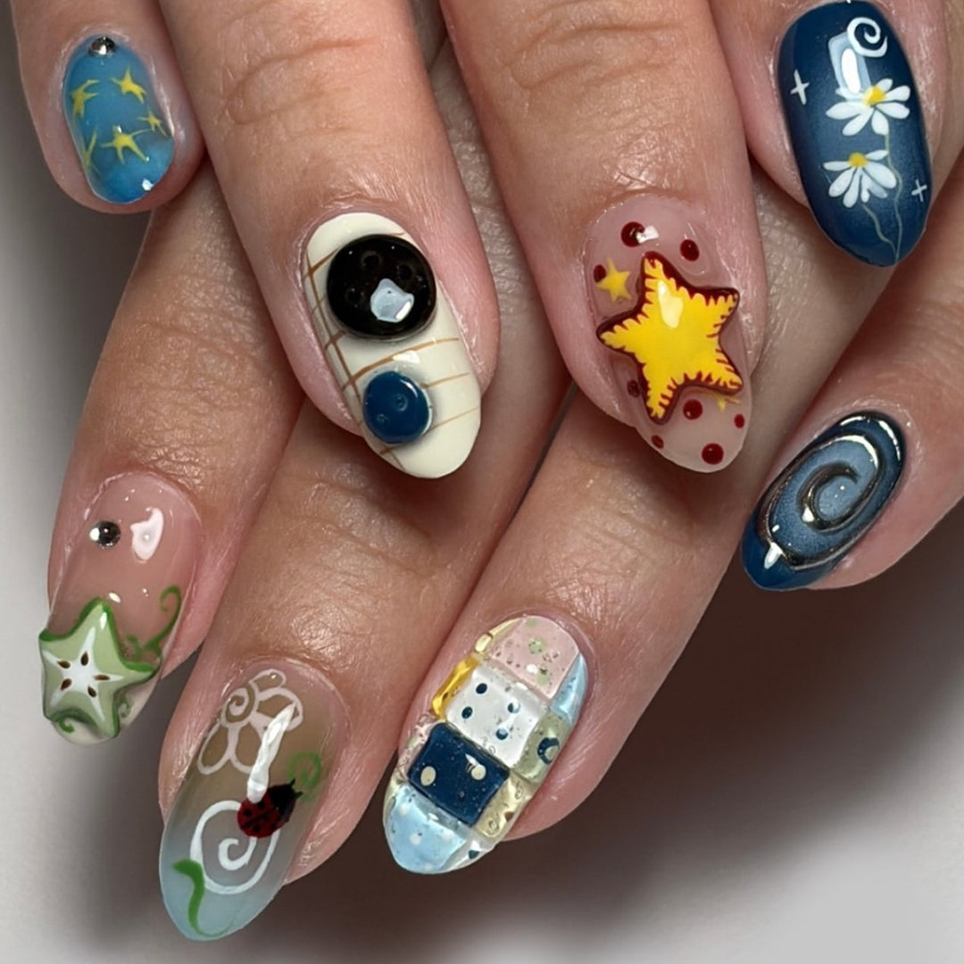 Artificial nails with creative maritime designs and 3D elements Stornfield