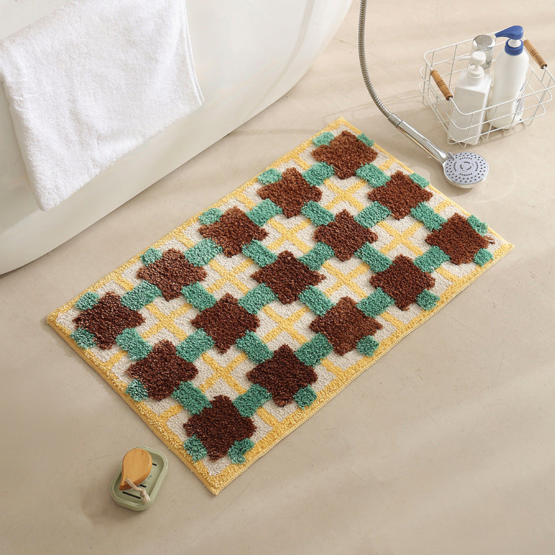 Hand-tufted bathroom bath mat with non-slip backing and textured square relief Stornfield