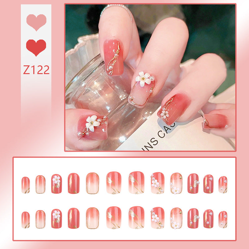 Acrylic nail set with elegant floral decorations and glamorous pearl accents Stornfield