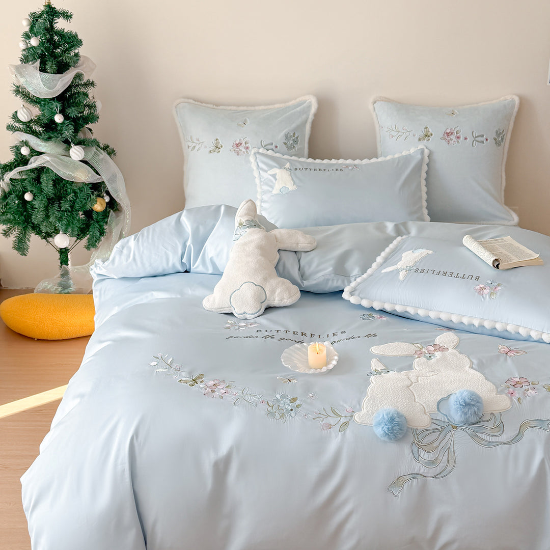 Playful cotton satin bedding set with appliquéd bunny pom-pom trim and floral embroidery