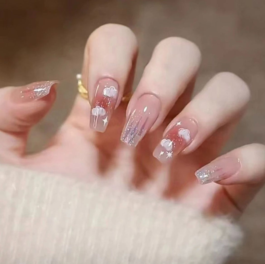 Artistic Nail Art with Glitter and Flower Applications Stornfield