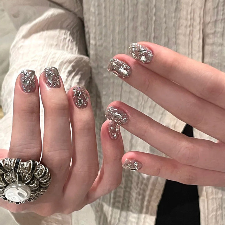 Artificial nail art with glamorous glitter accents Stornfield