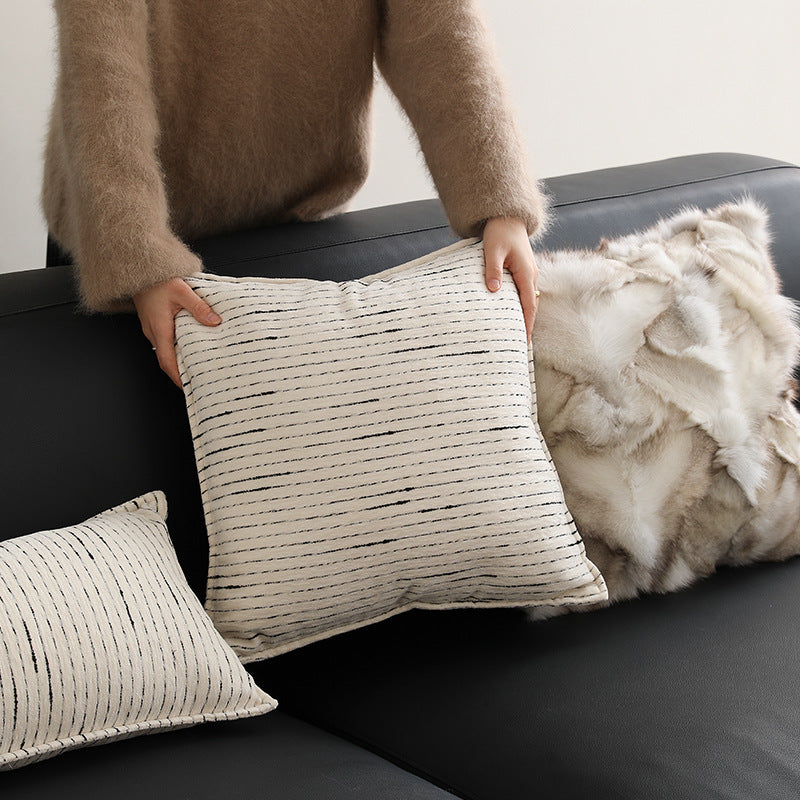 Rectangular quilted decorative cushion with fine line embroidery and natural linen texture
