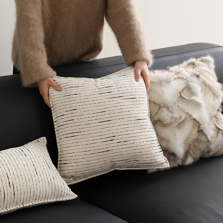 Rectangular quilted decorative cushion with fine line embroidery and natural linen texture
