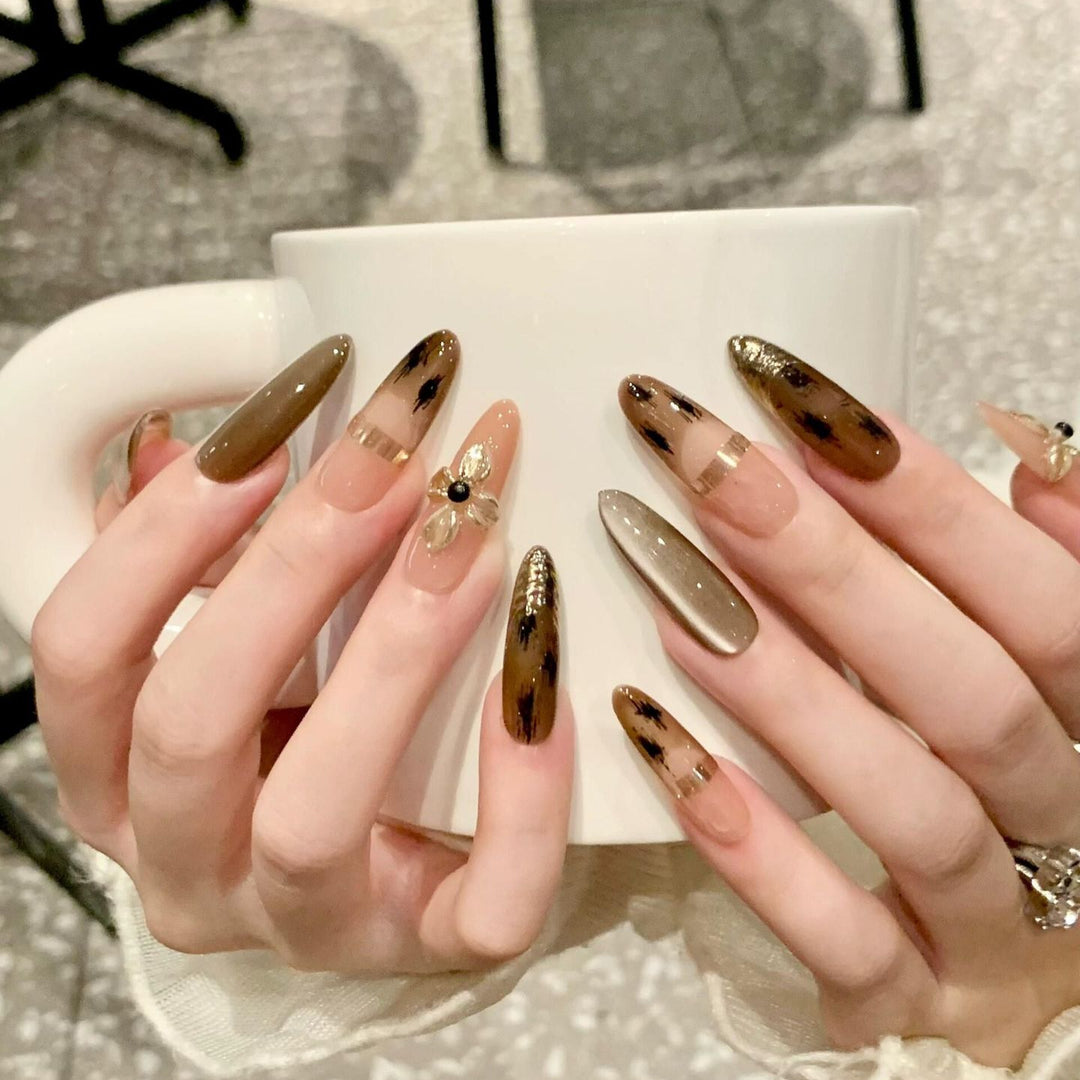 Artificial nails with elegant gold embellishments Stornfield
