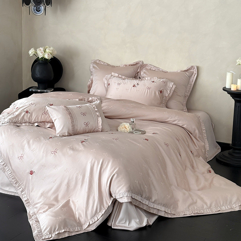 Luxurious satin bedding set with delicate floral embroidery and ruffles