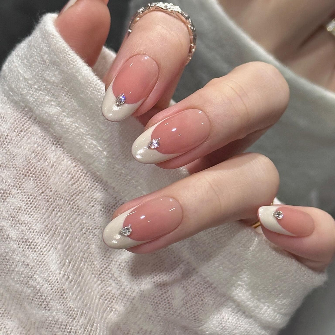 Artificial nails with elegant French style and sparkling accents Stornfield