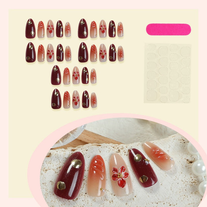 Acrylic nail set with elegant floral accents and glitter details Stornfield