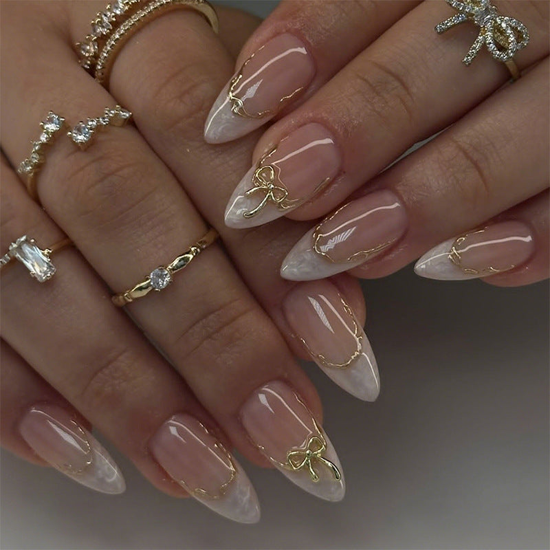 Artificial nails with elegant tip decorations and golden accents Stornfield