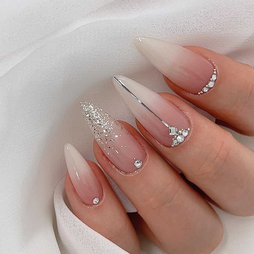 Glamorous stiletto nails with glitter and rhinestone accents Stornfield