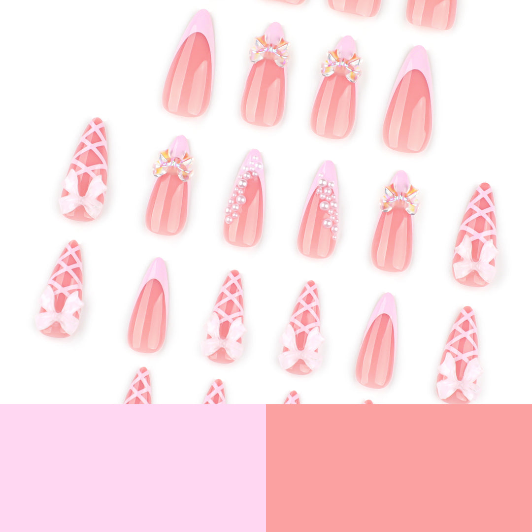 Artful stiletto nails with glitter and bow decoration Stornfield