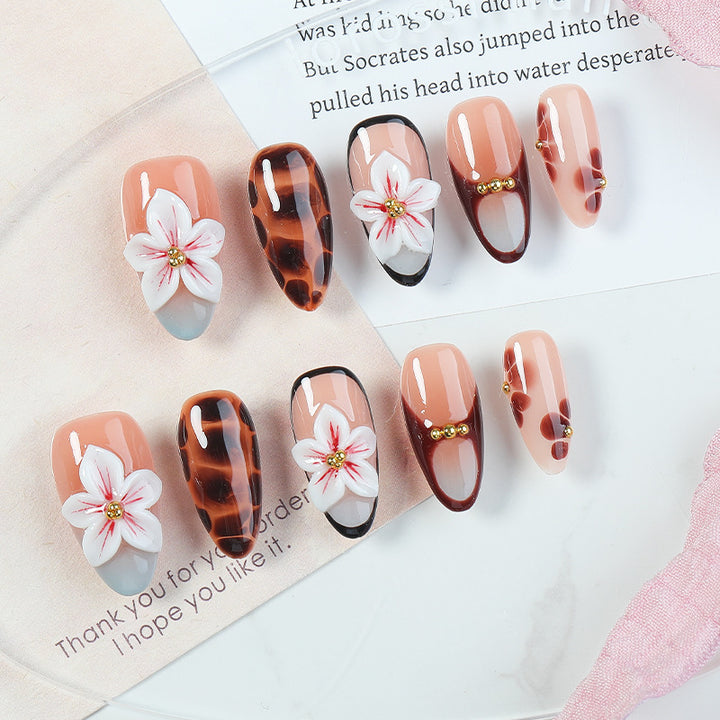 Acrylic nail set with floral accents and elegant embellishments Stornfield